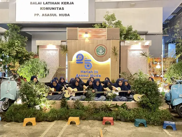 Santri putri bermain gitar di depan panggung Harlah 25